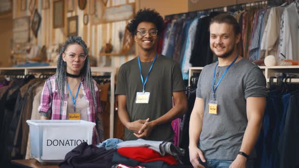 Portrait of Young Diverse Volunteer Group with Clothes for Donation