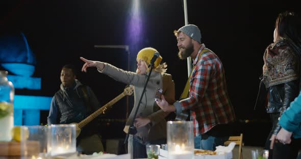 People Dancing To a Live Band on an Cold Urban Rooftop