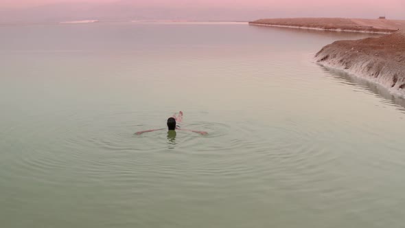 Woman Bathes in the Dead Sea. 