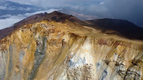 people on the edge of curating a bigger volcano