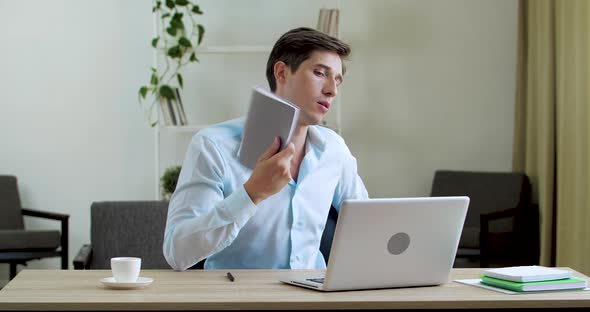 Male Worker Tired Sitting in Office Without Air Conditioning Ventilation Problems, Feeling Irritated