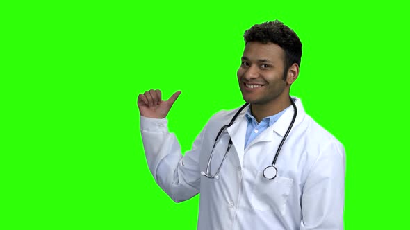 Cheerful Doctor Pointing To Copy Space.