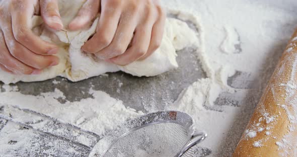 Woman kneading a dough 4k