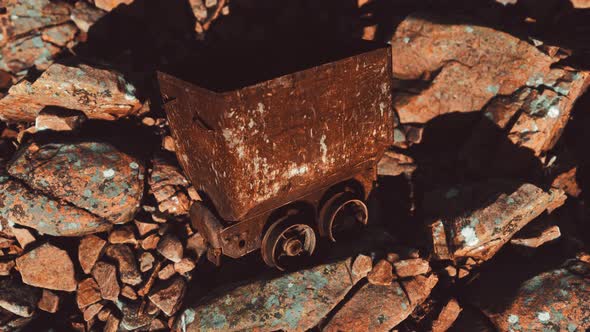 Abandoned Rusty Mine Cart on Rocks alt