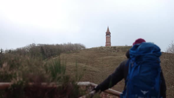 Tourist with Backpack Enjoys View of the Tower on Himmelbjerget Hill Denmark