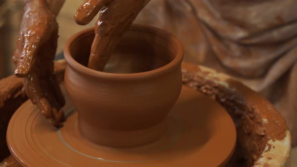 Hands of a Potter Creating an Earthen Jar on the Circle