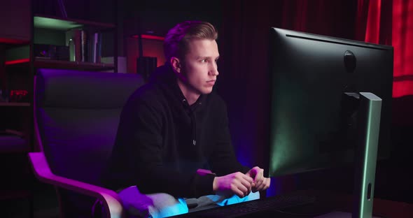 A Young Man is Typing on a Computer