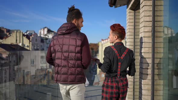 Back View Positive Man and Woman Walking in Slow Motion on Terrace Leaving in Kyiv Ukraine