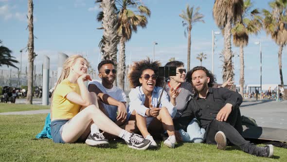 Laughing Friends Taking Selfie on Meadow