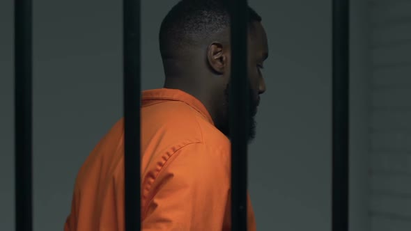 Depressed Black Prisoner Walking in Cell