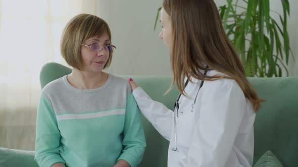 Doctor Visiting Elderly Woman at Home