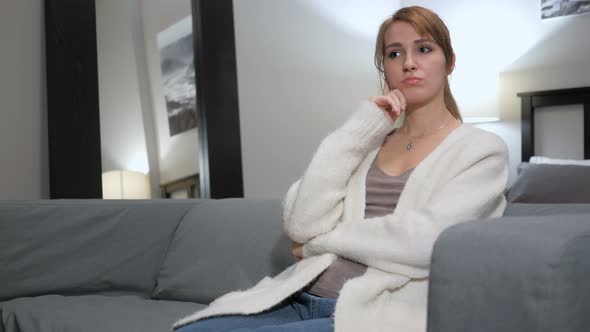 Pensive Woman Thinking, Sitting on Couch in Bedroom