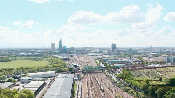 Drone shot over train leaving London near wormwood scrubs Acton