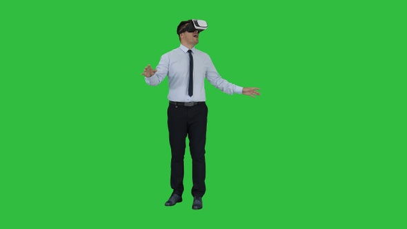 Astonished young businessman wearing VR glasses Concept