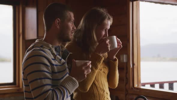 Caucasian couple spending time at home together, drinking a beverage