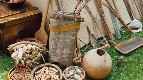 Weapons, Dishes and Other Household Items of Indians Near the Wigwam