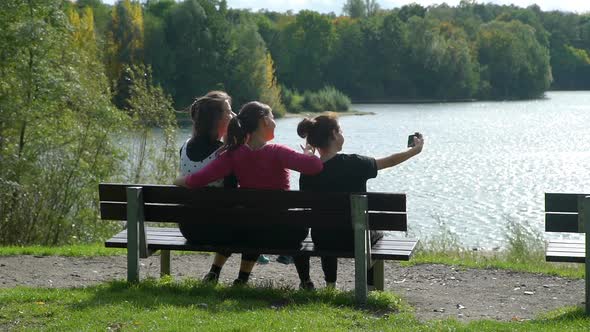 Three Sisters Taking Selfie in the City Park