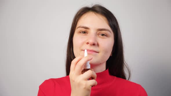 A Patient Shoves a Spray Into the Nose to Treat Rhinitis an Allergy with Difficulty Breathing