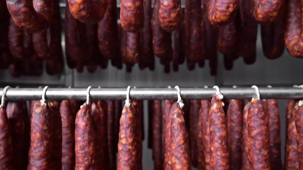 Close Up View of Typical Spanish Dried Sausage Chorizo Hanging on Rack at Meat Processing Plant