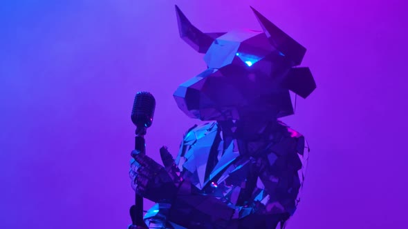 Shiny Bull in Costume Made of Mirrors Singing and Dancing Near Retro Microphone on Neon Blue Pink