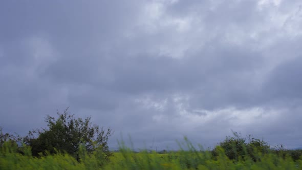 Car view of a stormy sky above field