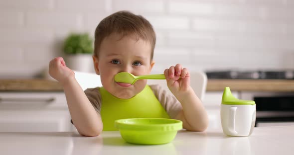 Little Boy Has Breakfast in the Kitchen