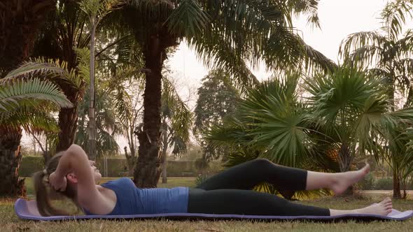 Non Professional Sportswoman Doing Abdominal Crunches While Lying on Sports Mat