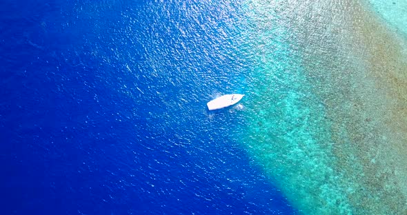 Tropical flying tourism shot of a paradise sunny white sand beach and blue water background in best 