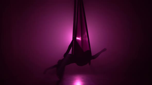 Silhouette Girl Dancing with Aerial Silk Flying Wings in Violet Background 071