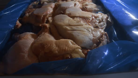 Closeup View of a Box Full of Frozen Chicken Legs