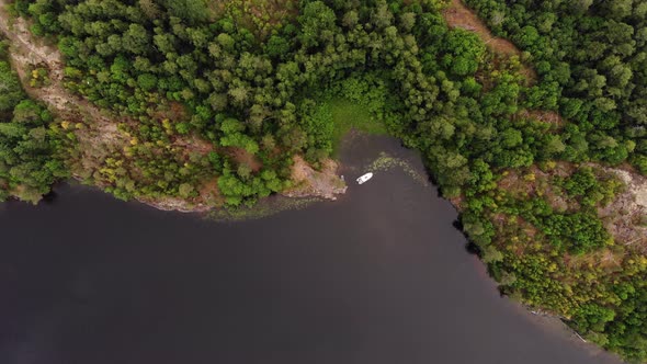 Boat anchored at quiet place of calm Murolahti bay, top-down aerial shot