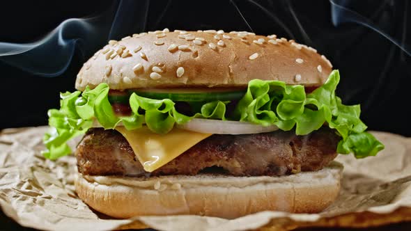 Big Appetizing Burger with Meat Cutlet, Onion, Vegetables, Melted Cheese, Lettuce and Mayonnaise