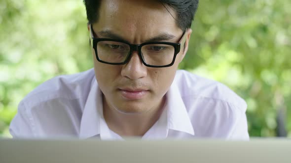 Asian Man Working with Laptop