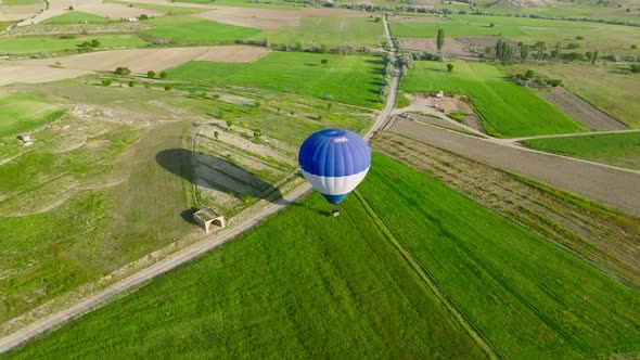 4K Aerial view of Goreme. Colorful hot air balloons fly over the valleys.