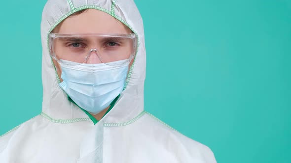 Man in Protective Suit Medical Mask and Goggles Looking at Camera