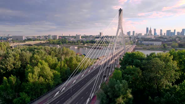 Aerial View of the Cable Bridge in the Sunset with City on the Background