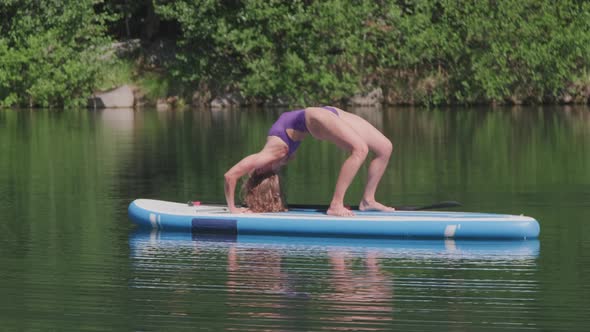 Practicing Yoga Poses on Sup Board