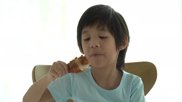 Cute Asian Child Eating Fried Chicken