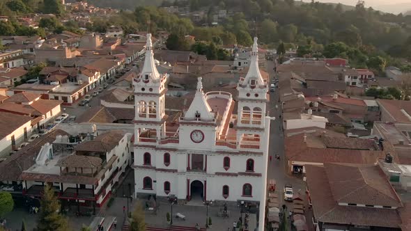 Overview of San Cristobal Church, Its Surrounding Houses, and Mountains in the Background in Mazamit