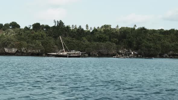 View From Ocean to Wooden Fishing Boats Anchored Near Coast of African Village