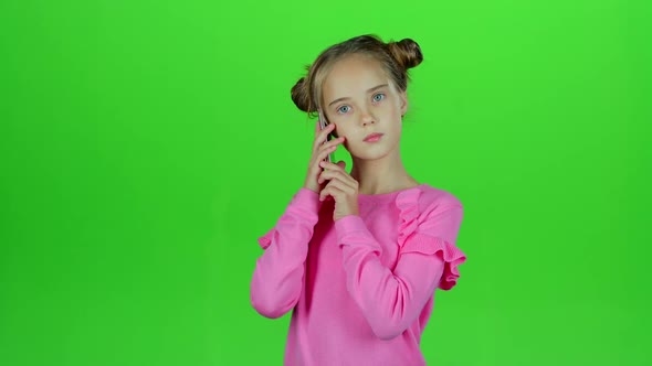 Baby Is Talking on the Phone with Her Mom. Green Screen