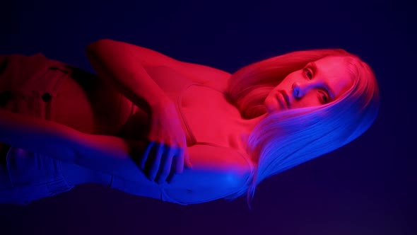 Beautiful Stylish Woman Model Posing in Neon Light