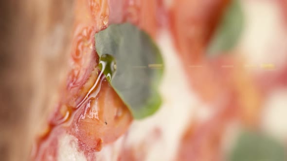Vertical video: Pizza drizzled with olive oil