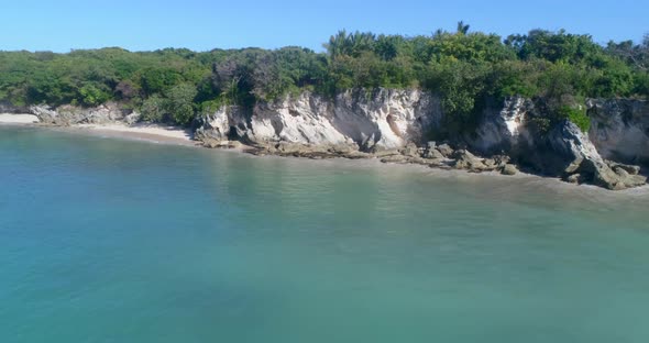 Drone shot off the coast of Macao in Punta Cana, Dominican Republic, view of the cliff, blue water,