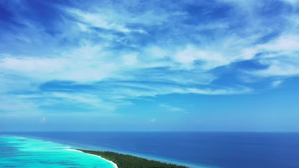 Luxury fly over travel shot of a summer white paradise sand beach and turquoise sea background in vi