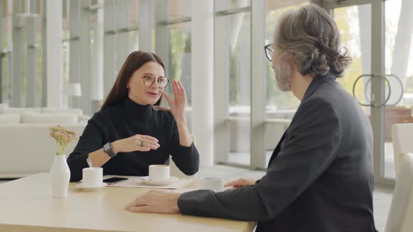 Business-Like Couple On Coffee Break At Restaurant