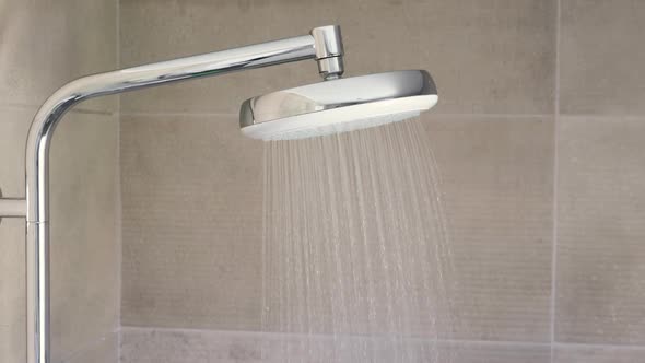 Shower Head at Tiled Bathroom Interior