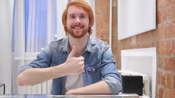 Portrait of Redhead Beard Man Gesturing Thumbs Up Indoor