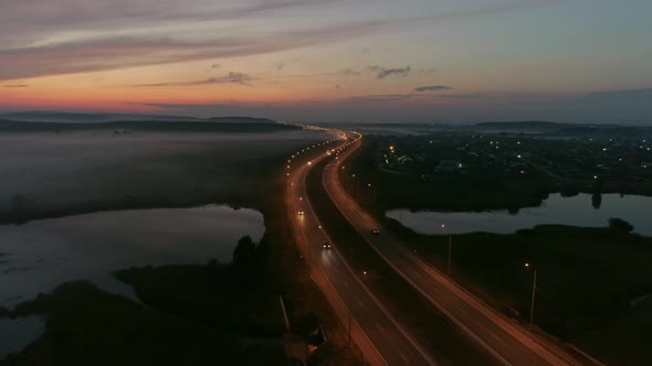 Aerial view of Cars drive on the night highway 07