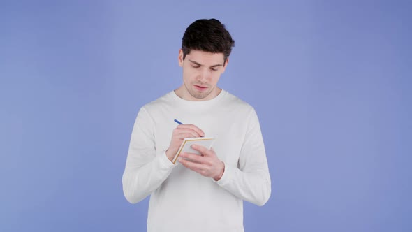 Man Making Notes in Planner Caucasian Guy Holding Pen